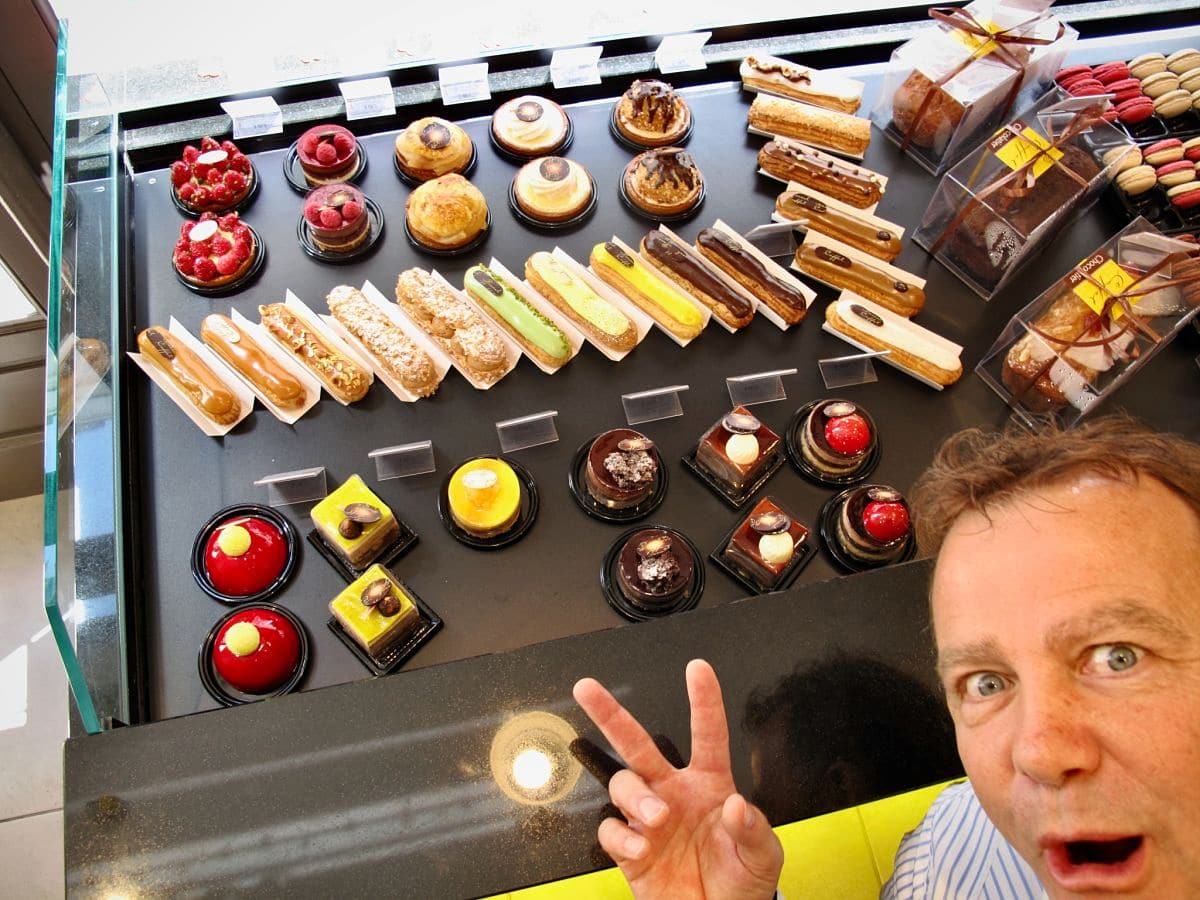 pastry chef poking his head out at the window of his patisserie