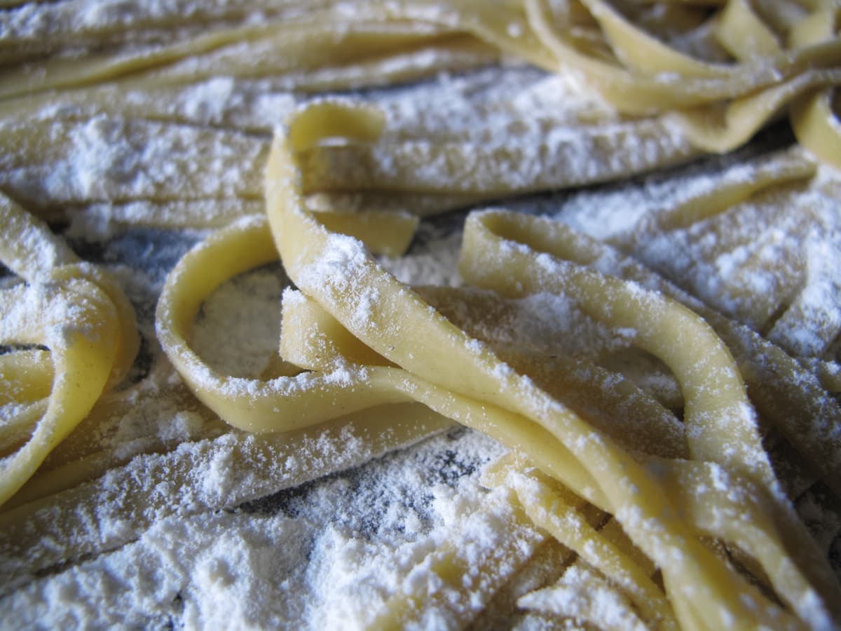 close-up pasta noodles covered in flour