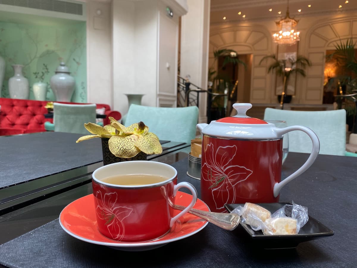 tea cup and teapot with exotic orchid