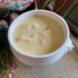 white lion bowl of creamy fish soup surrounded by tartan and heather