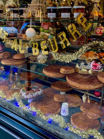 Paris bakery window filled with galettes des rois king cakes