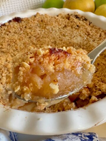 spoonful of apple crumble topped with crunchy toasted oats