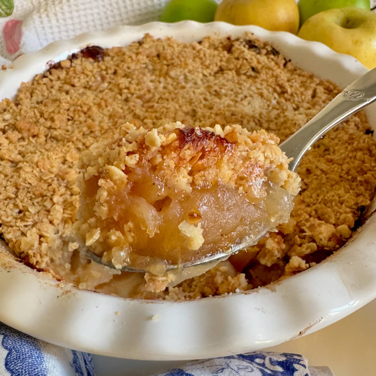 spoonful of apple crumble topped with crunchy toasted oats