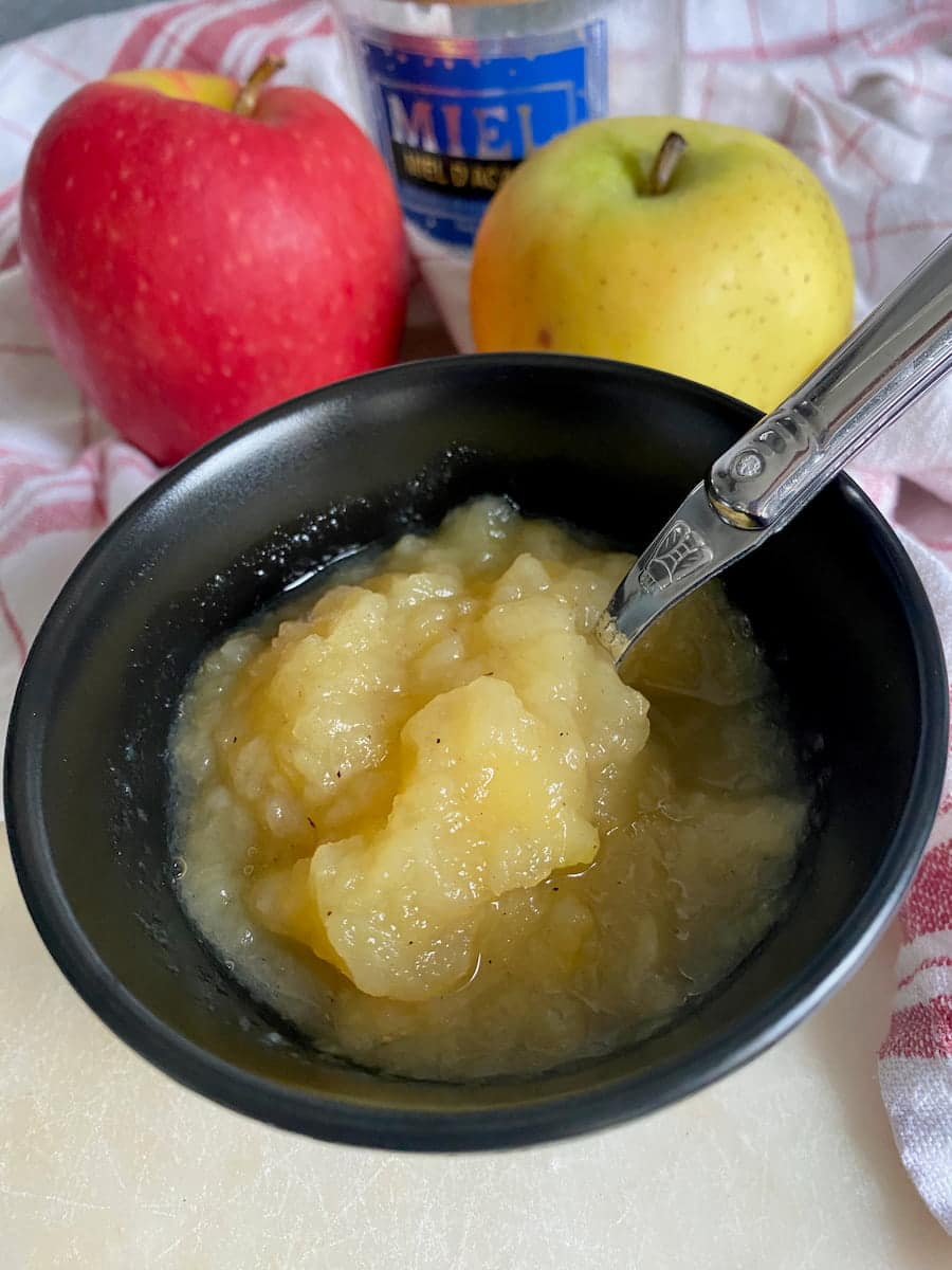 bowl of stewed apple with vanilla flecks, served with bits in it