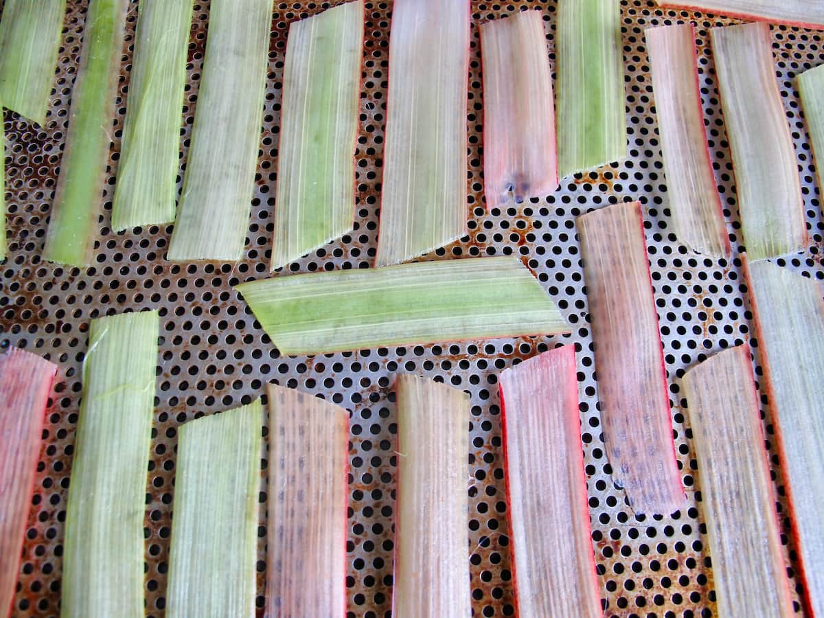 thin slices of rhubarb drying on a baking tray