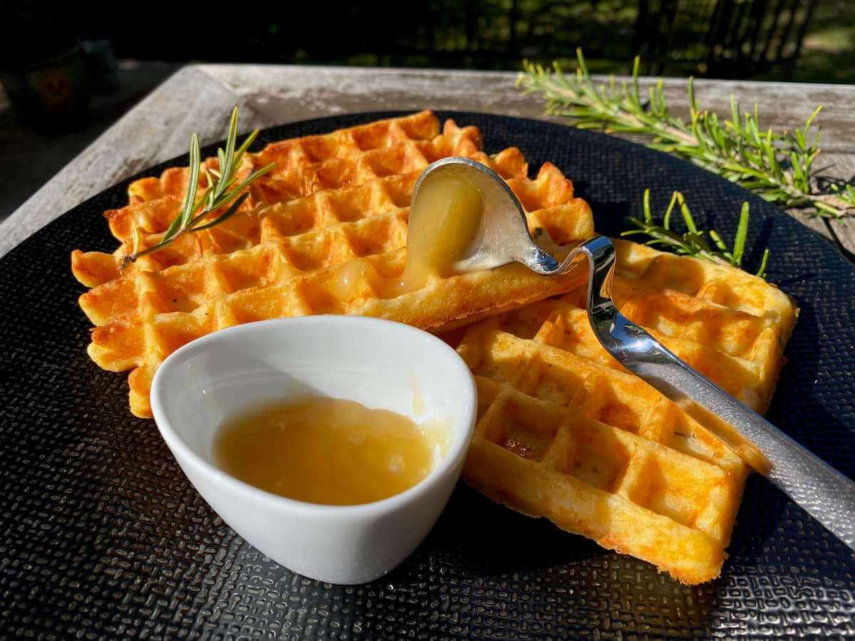 golden toasted waffles with a spoonful of honey and rosemary