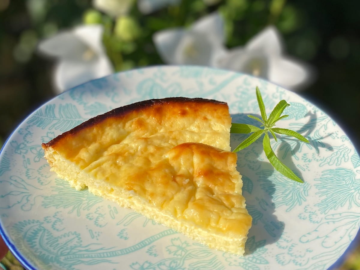 thin slice of Corsican cheesecake on flowery plate with lemon verbena