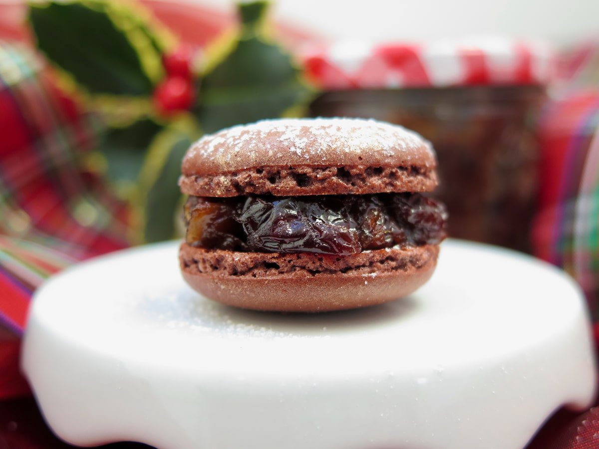 close-up brown macaron filled with dried fruits and dusted with icing sugar