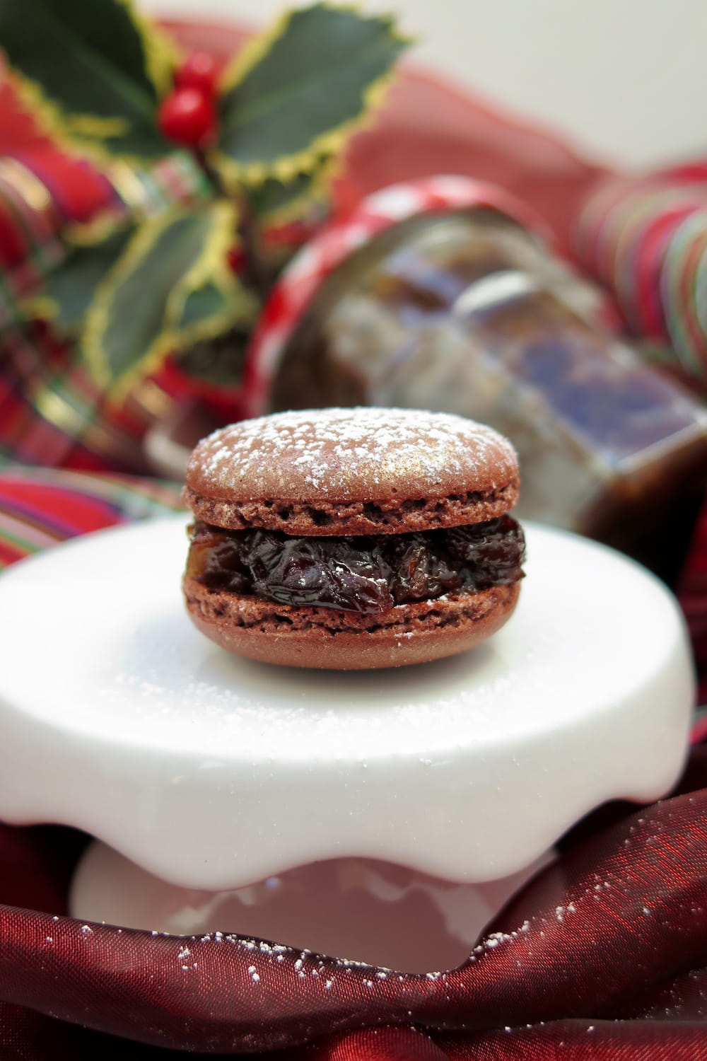 mince pie macaron with holly and jar of mincemeat