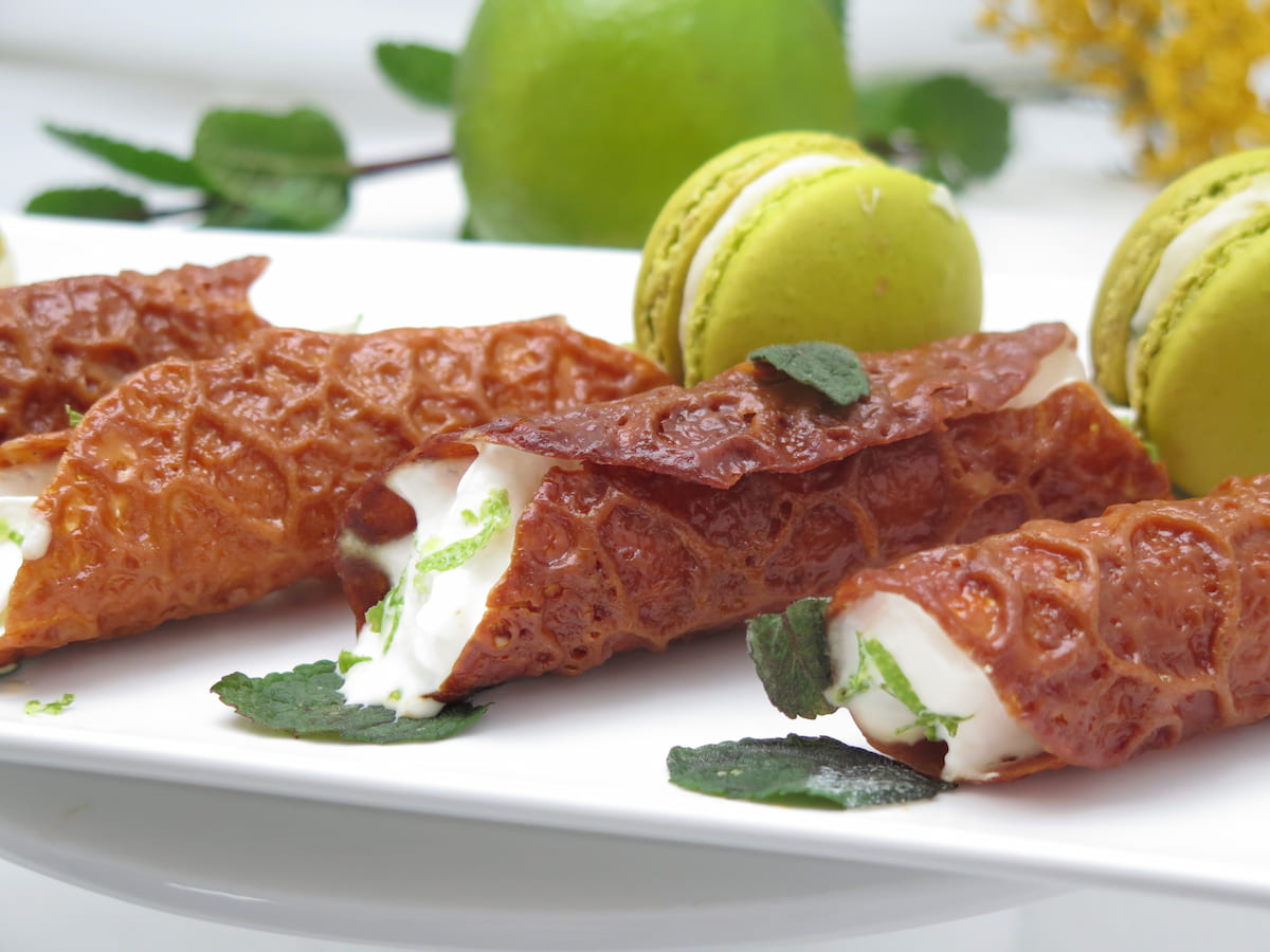 close up of traditional brandy snaps, filled with whipped cream and a little Brandy or rum