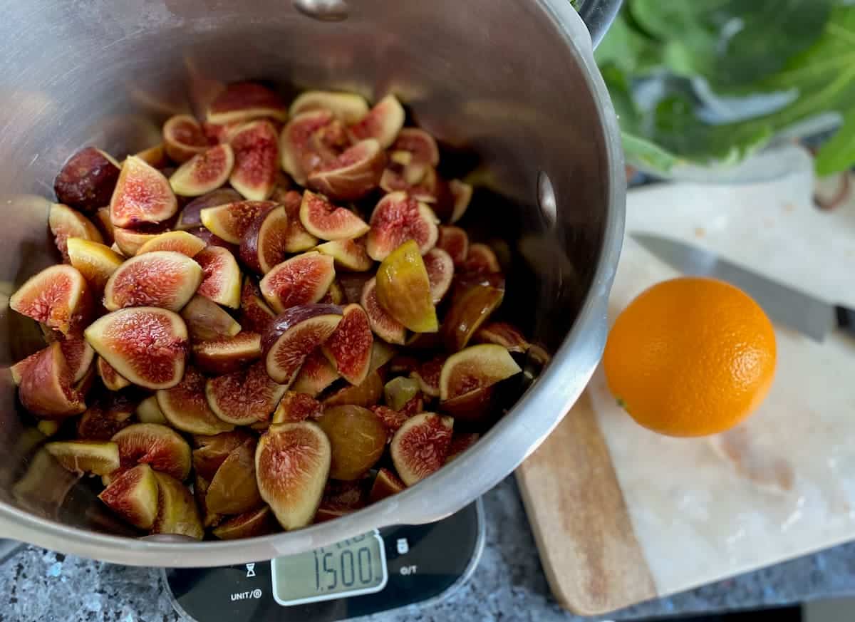 measuring chopped fresh figs in a bowl on digital scales