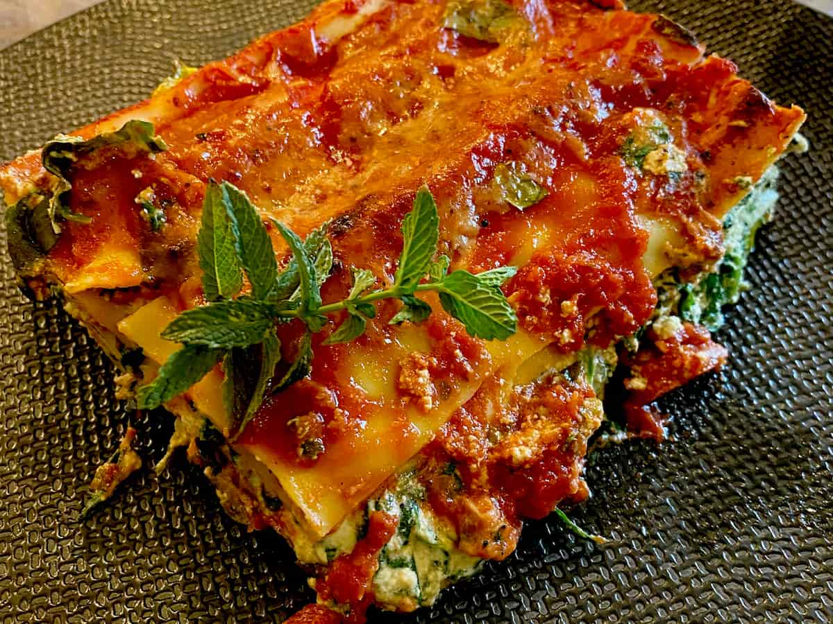 layers of lasagne with tomato, cheese and mint