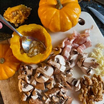 scooping out seeds of mini pumpkins