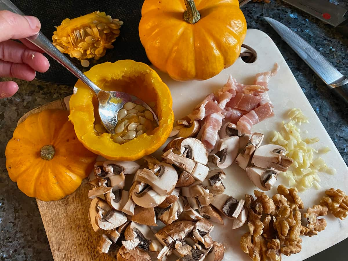 scooping out seeds of mini pumpkins