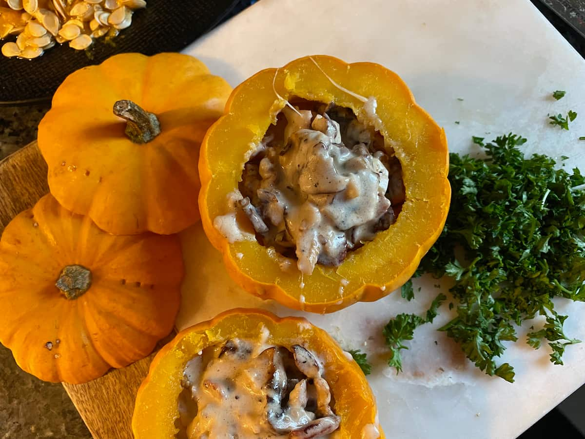 looking down on to mini pumpkins stuffed with mushrooms and cream