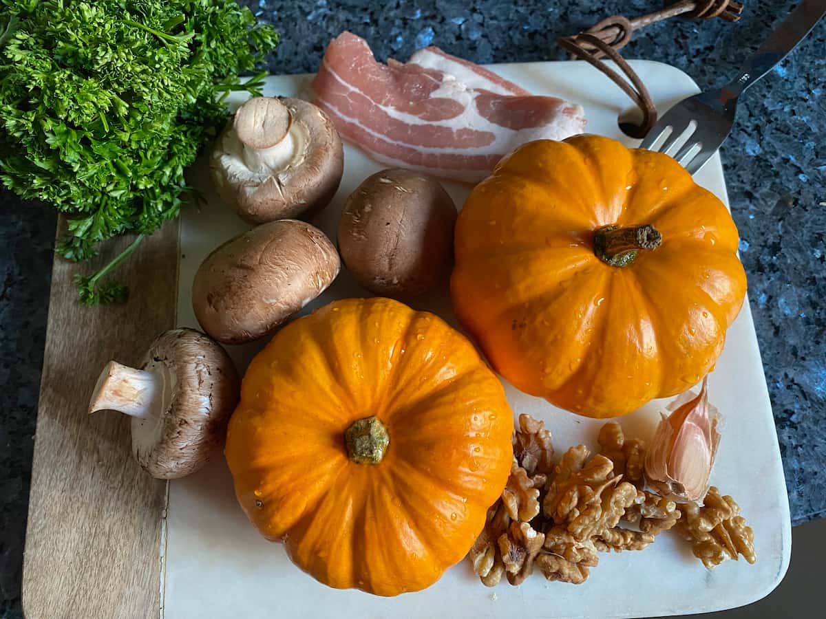 little orange mini pumpkins surrounded by stuffing ingredients