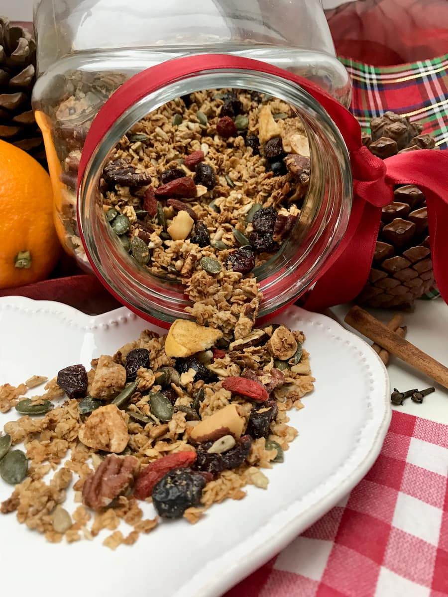 cookie jar pouring out toasted granola with oats, nuts and dried berries
