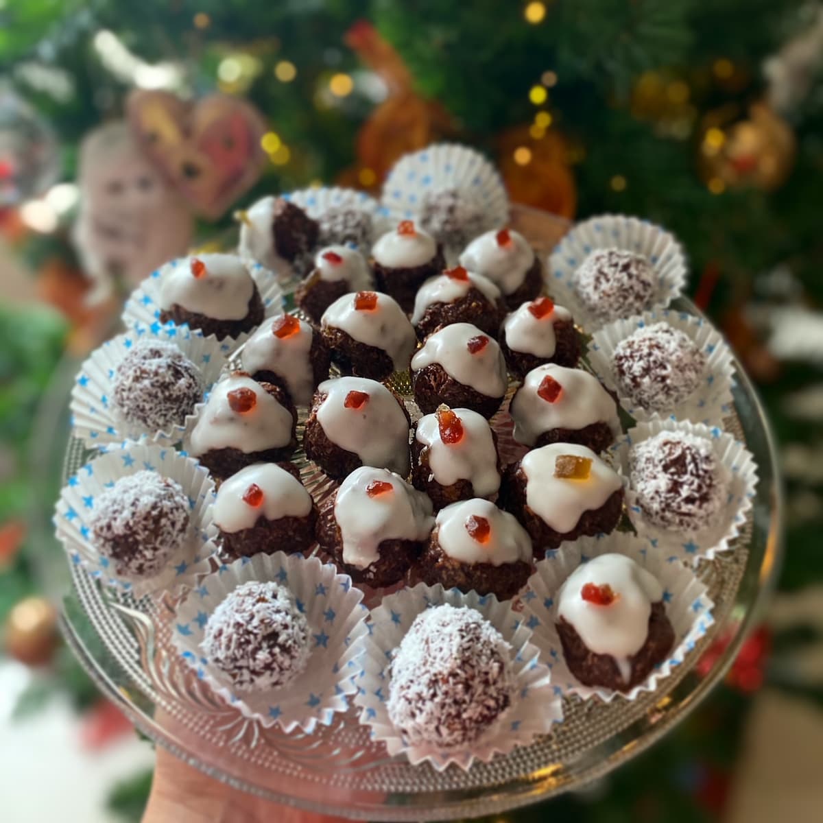 plate of christmas sweet treats in front of the tree