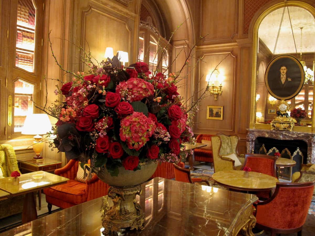 bouquet of red roses and hydrangea flowers on a table in the chic salon in Paris