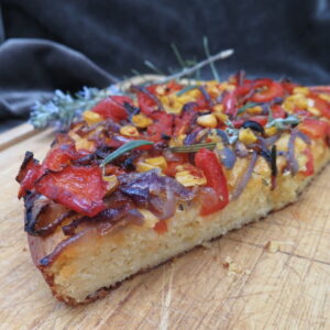 cornbread sliced as cross-section with colourful roasted veg on top