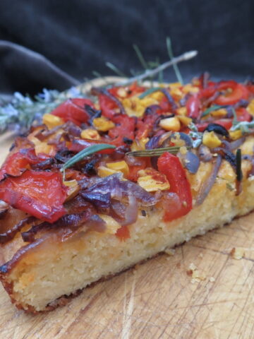 cornbread sliced as cross-section with colourful roasted veg on top