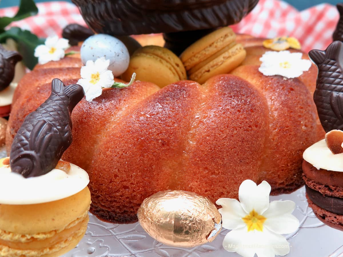 close-up of a lemon drizzle cake with flowers and Easter eggs