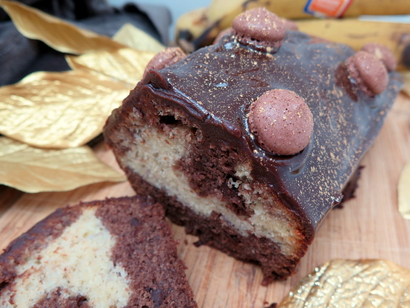 Chocolate Banana Marble Cake topped with a fudge glaze and macaron shells