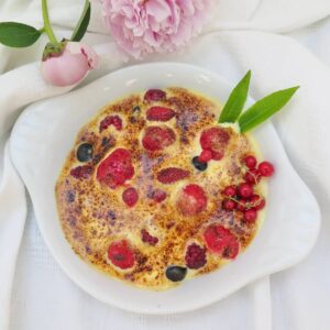 gratin dish of berries in a creme brulee cream