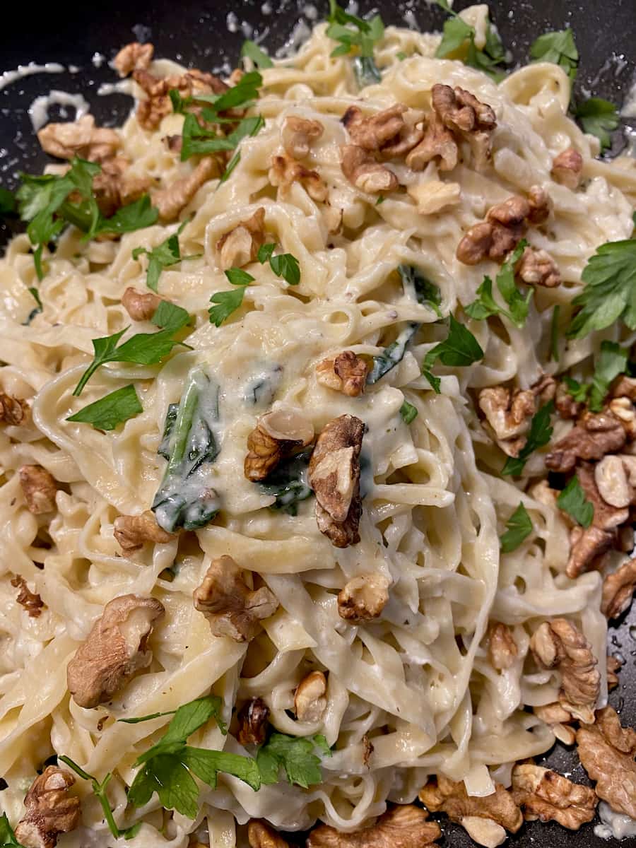 fresh noodles tossed in melted goat cheese and cream with freshly chopped parsley and walnuts
