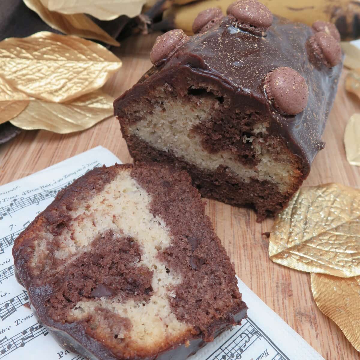 slice of chocolate and banana cake topped with a fudgy chocolate glaze