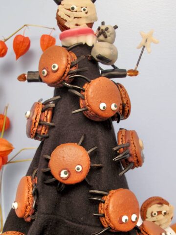 black cone witch's hat with chocolate macarons with eyes and spider liquorice legs