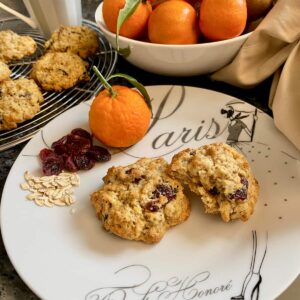 plate with 2 cranberry cookies next to clementine oranges