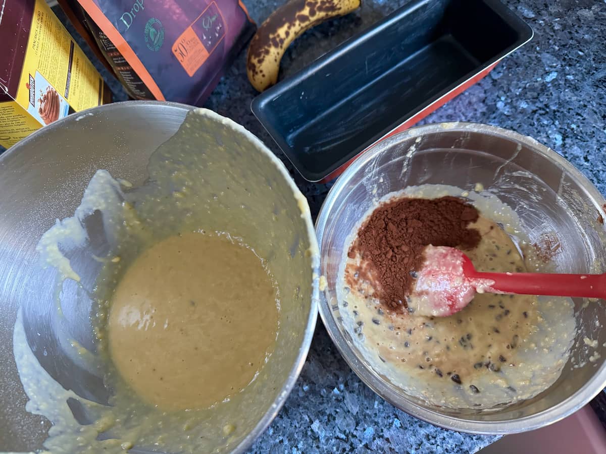 two bowls containing dark chocolate batter and yellow banana batter