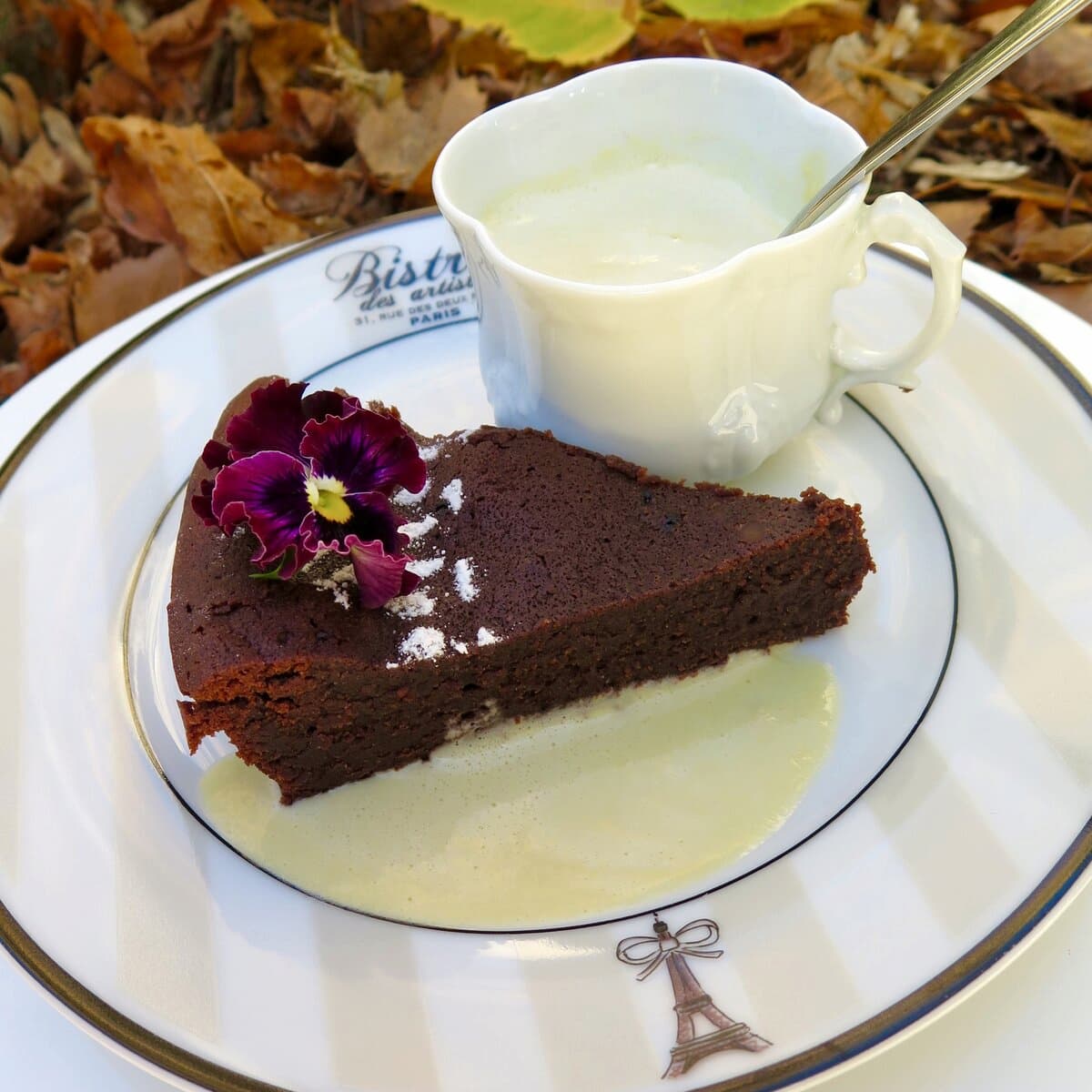 slice of chocolate plate with eiffel tower served with a thin custard sauce