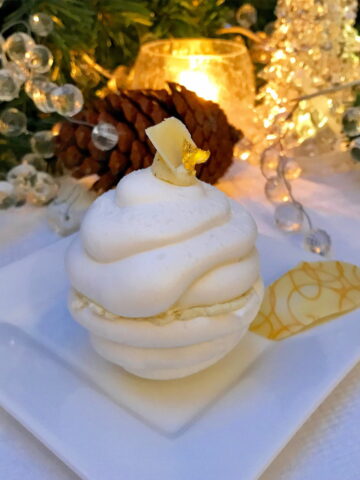 2 white meringue halves stuck together with cream to look like a melting snowball cake