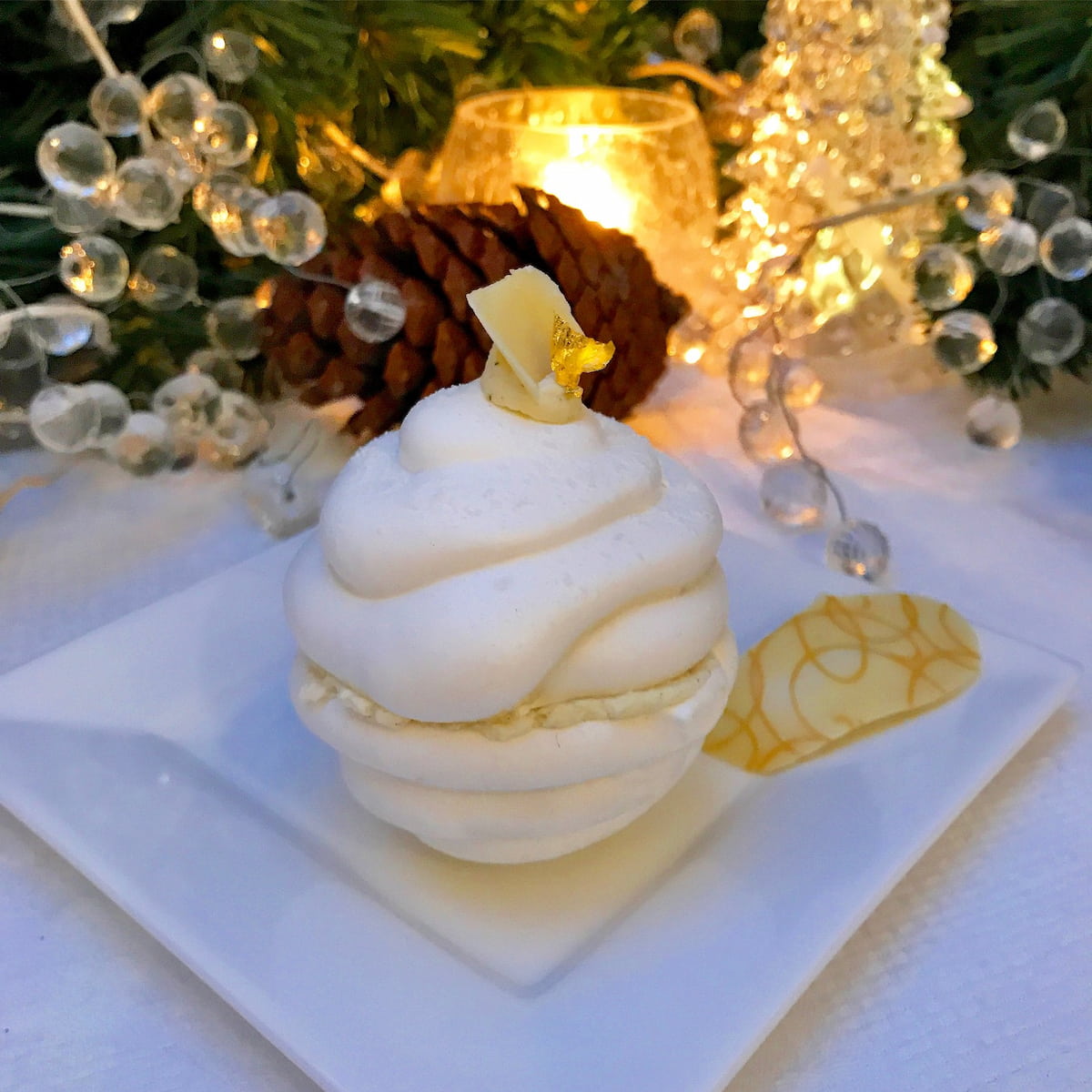 2 white meringue halves stuck together with cream to look like a melting snowball cake