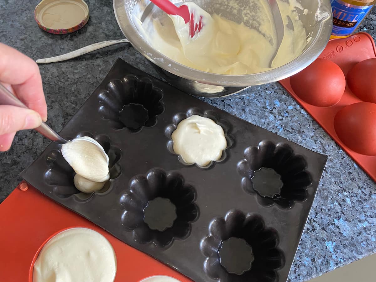 pouring creamy mixture into moulds