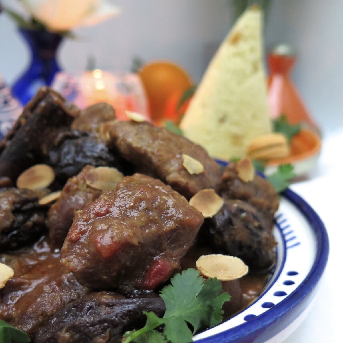 prune tagine of chicken or turkey with toasted almonds and cone of semolina in background