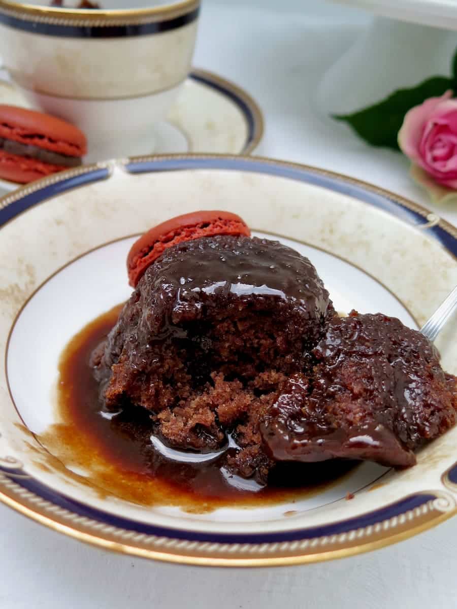 bowl of lush dark pudding smothered in toffee sauce