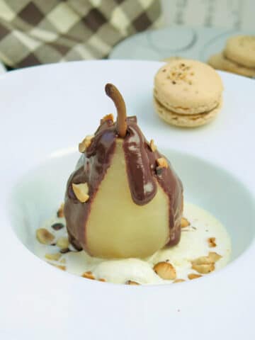 Pear Belle Helene, a poached pear on ice cream topped with chocolate sauce