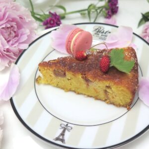 rhubarb rose cake slice with rose macaron and peonies