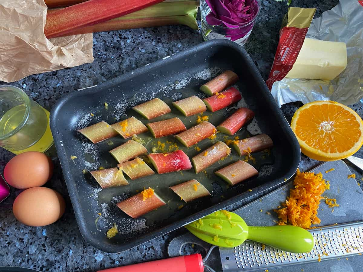 roasting tin with chopped rhubarb in orange juice, zest and a little sugar