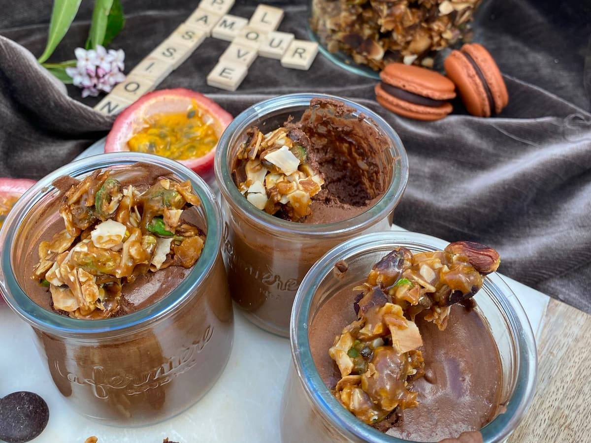 chocolate mousse with passion fruit, topped with caramel nougat macarons in background