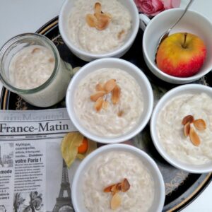 ramekin dishes filled with rice puddings topped with toasted flaked almonds