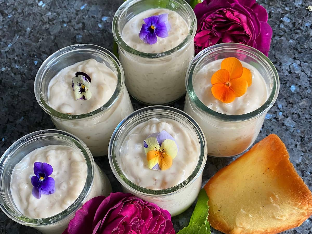 glass pots of rice pudding topped with edible pansies