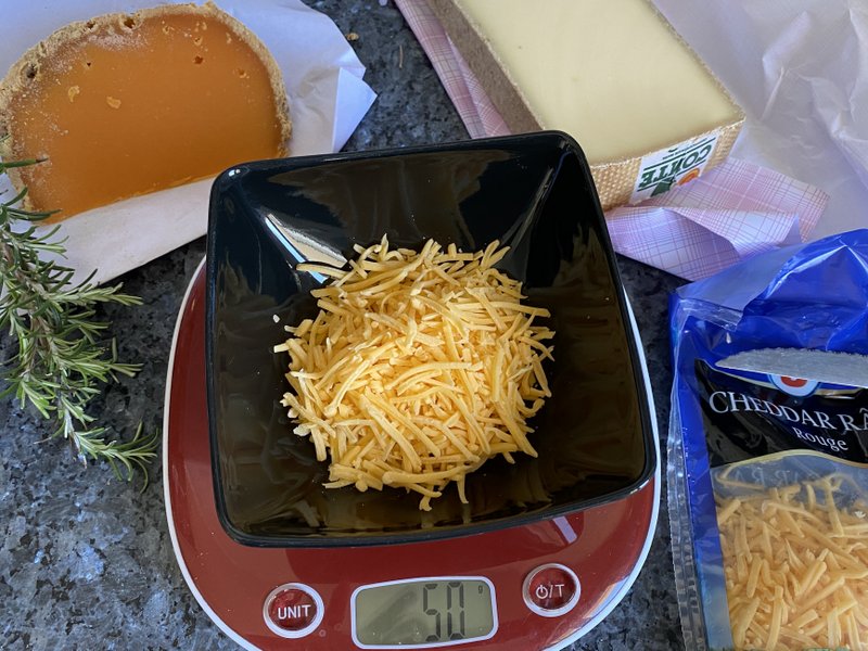 weighing out grated cheddar cheese to make scones