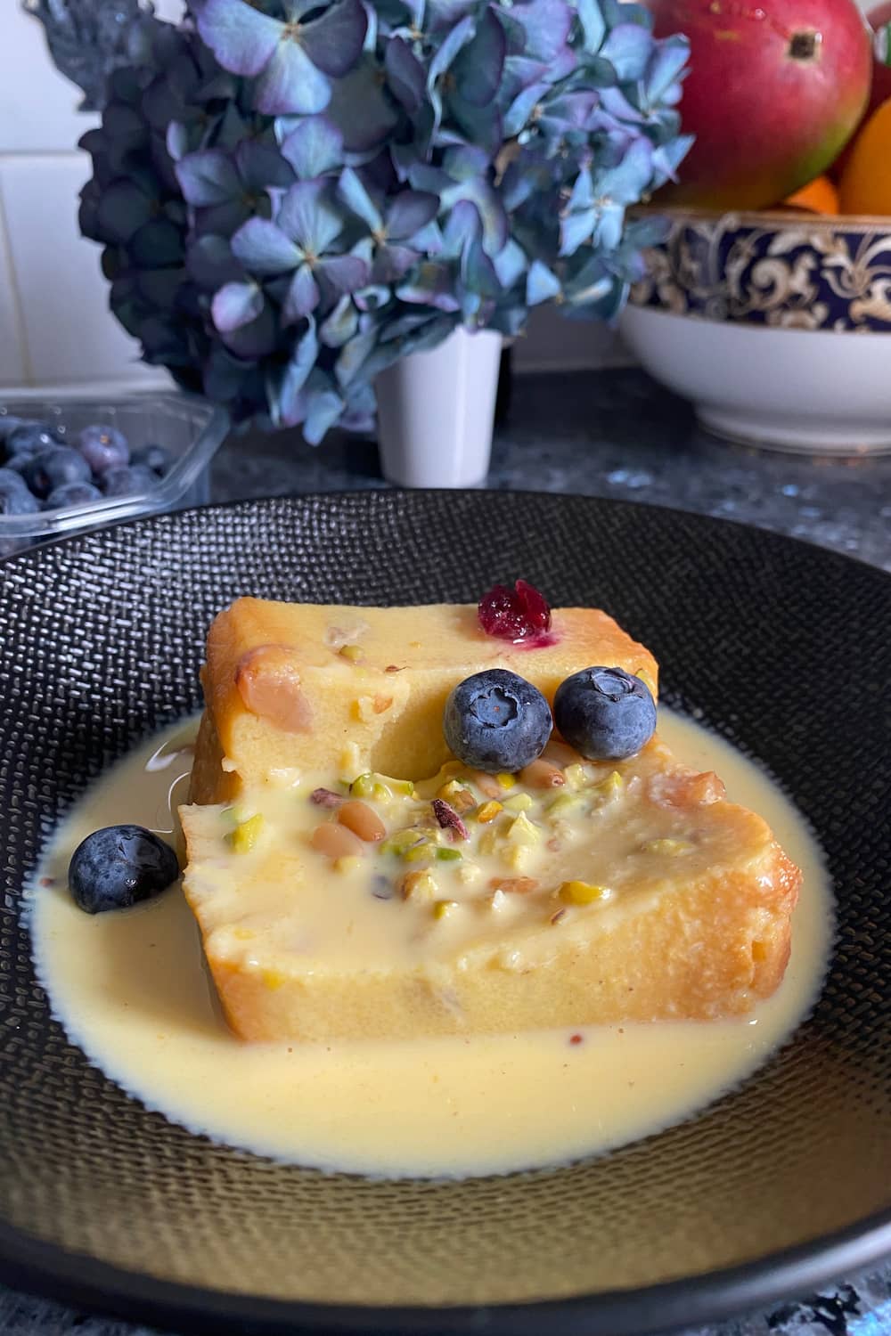 semolina cake slices in a bowl with creme anglaise custard