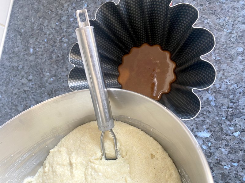 semolina batter about to go into a cake mould with caramel