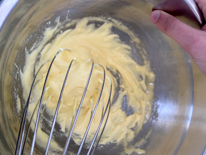 whisking the sugar and egg yolks until creamy