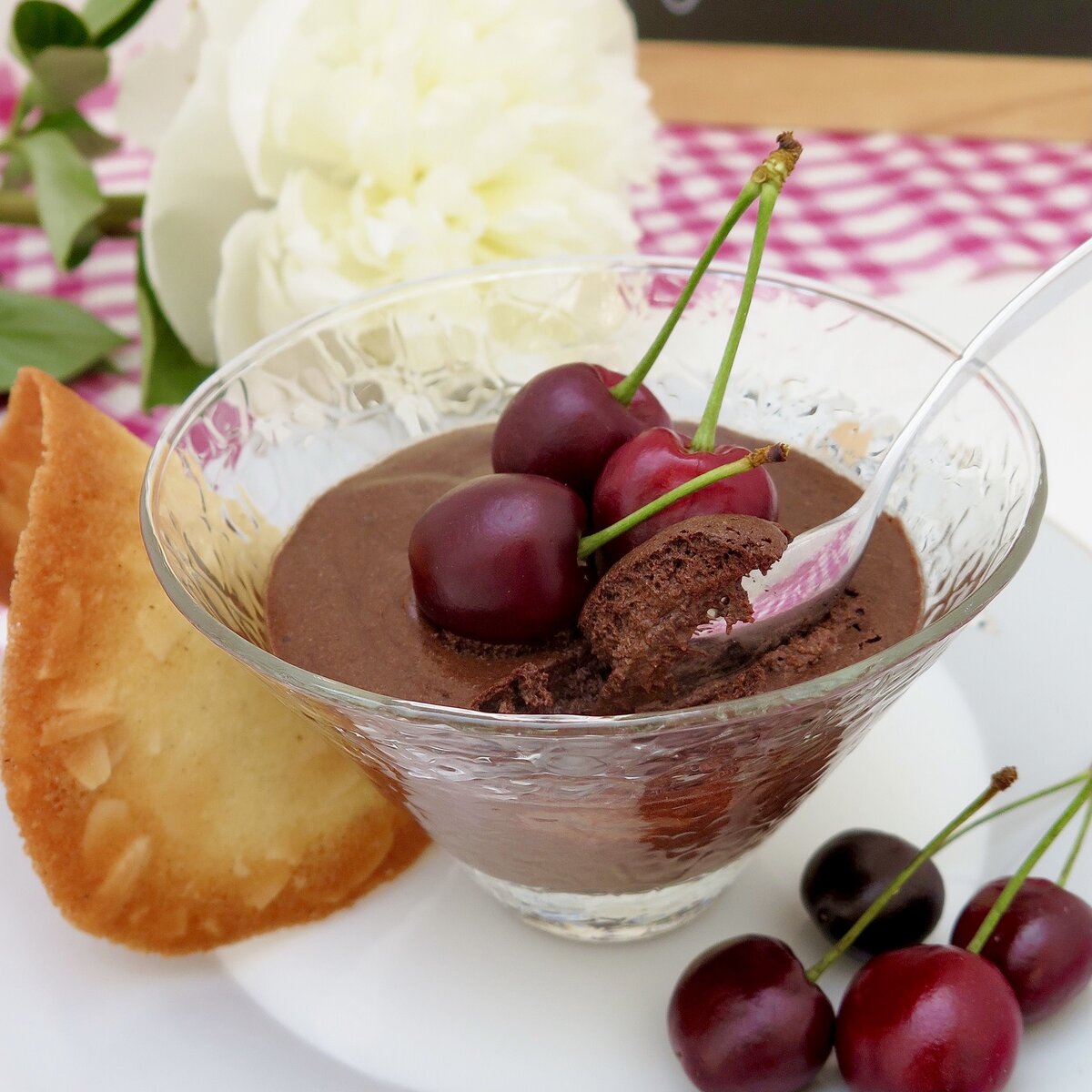 glass dish of chocolate mousse with cherries